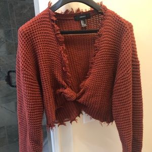 Crop sweater with a knotted front.